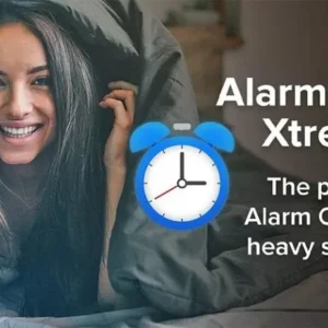 A person is holding a phone with the Alarm Clock Xtreme app open.